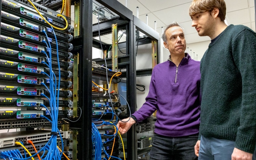 researchers looking at a software rack